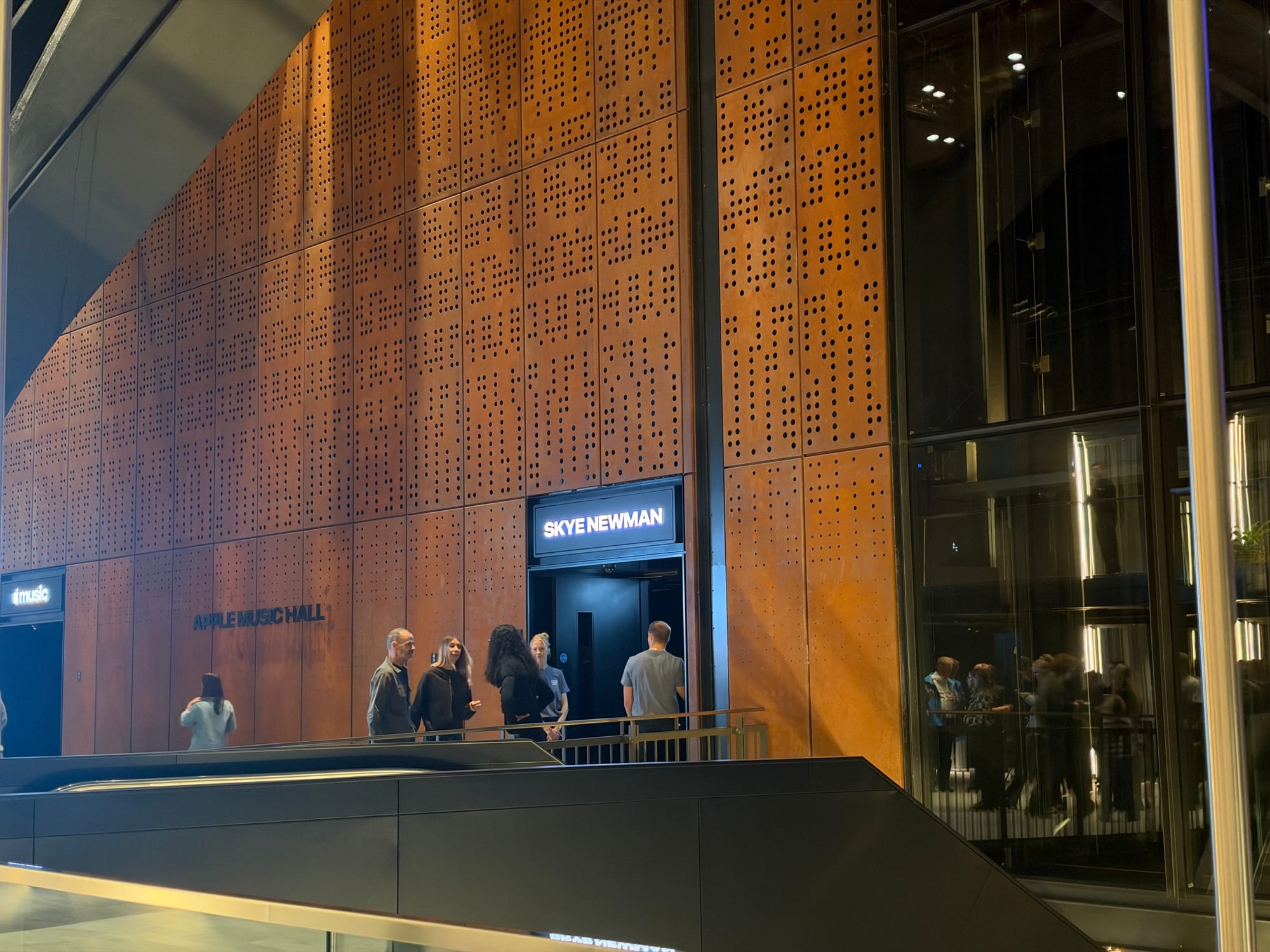 Text that reads Skye Newman above the entrance, and a dedicated sign that says Apple Music Hall