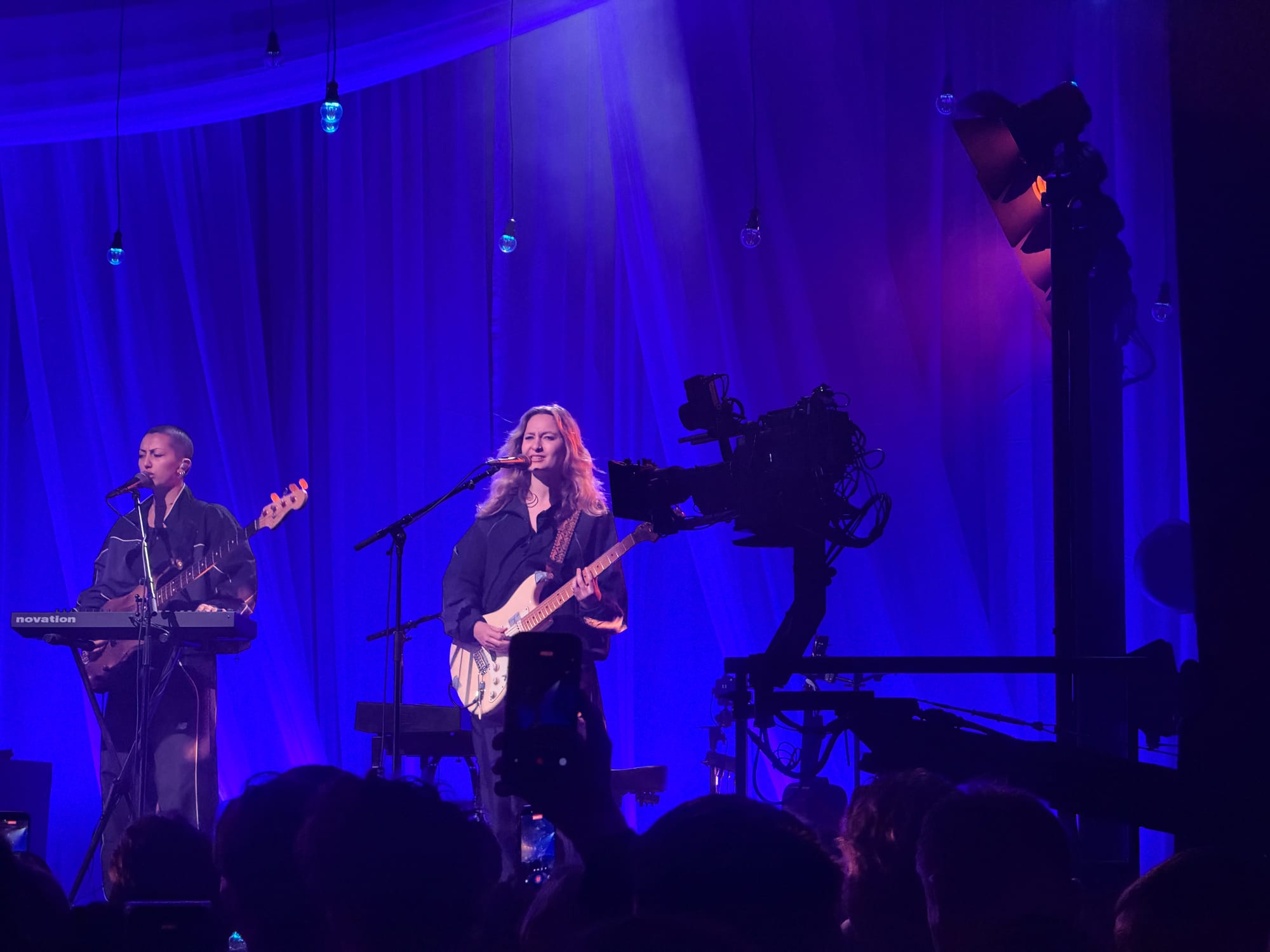 The band with two female guitarists and a camera.